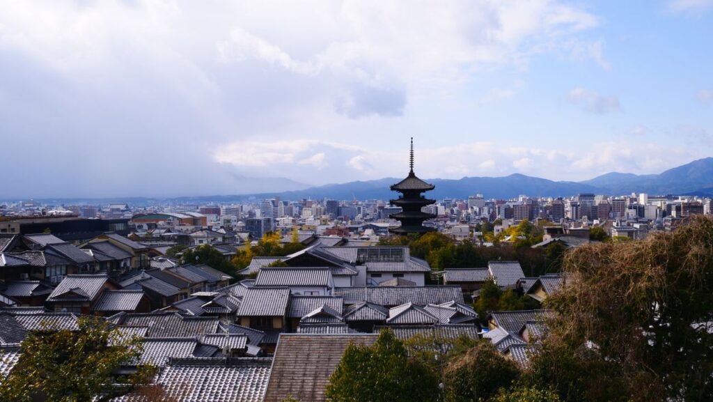 A breathtaking view of Kyoto city with traditional pagoda and modern skyline.