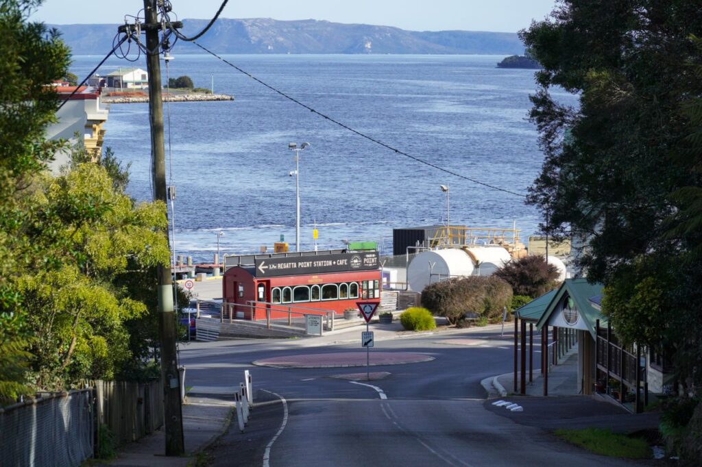Charming view of Strahan's waterfront with picturesque buildings and serene water, Tasmania, Australia.